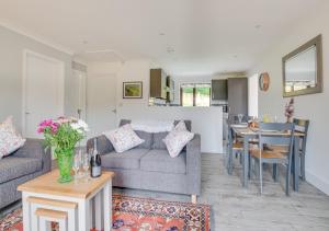 a living room with a couch and a table at Valley View in Upper Hardres