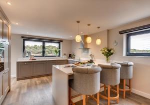 a kitchen with a table and chairs and a counter at Vause at Sea in Kingsdown