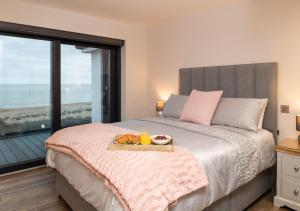 a bedroom with a bed with a tray of food on it at Vause at Sea in Kingsdown