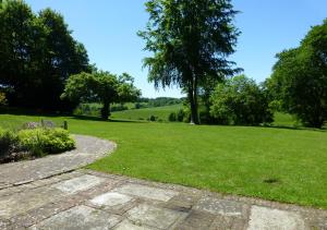 a walkway in a park with a green field at Well Cottage in Barham