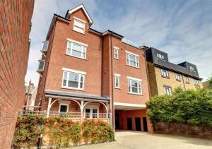 a large red brick building with white windows at York Mansions Apartment in Broadstairs