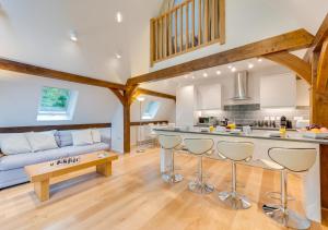 a large kitchen and living room with wooden beams at Waterside Lodge in Bodiam