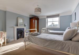 a bedroom with two beds and a fireplace at West Ascent in Hollington