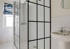 a bathroom with a shower and a sink at West Ascent in Hollington