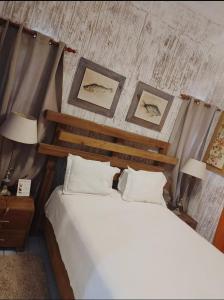 a bedroom with a bed and two pictures on the wall at Vista Marina Residence in Boca Chica