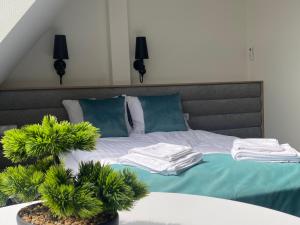a bedroom with a bed with towels on it at Apartamenty Wodna 13 in Poznań