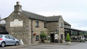 a building with a car parked in front of it at Elm Croft in Old Brampton