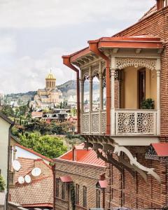 a balcony of a building with a view of a city at Siqvaruli in Tbilisi City