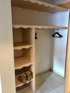 a room with a closet with wooden shelves at Appartement Les Orres 1800 - Vue montagne in Les Orres