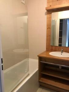 a bathroom with a shower and a sink and a tub at Appartement Les Orres 1800 - Vue montagne in Les Orres