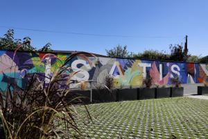 a wall with a mural on the side of it at RESIDENCE SWEETLY ISATIS in Mérignac