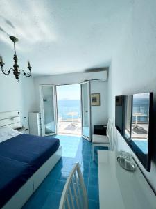 a bedroom with a bed and a table with a view at Hotel Casa Sofia in Ischia