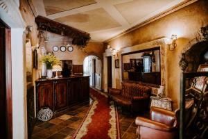 a living room with a couch and a table and chairs at Hotel Senator in Zamość