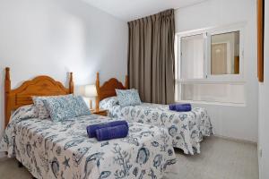 a bedroom with two beds and a window at Callao Beach 3 in Arrieta