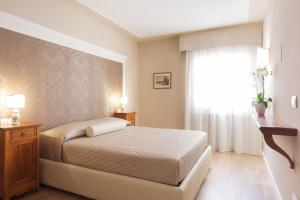 1 dormitorio con cama y ventana en La Perla Apartment en Verona