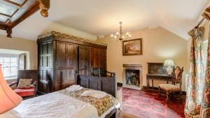 a bedroom with a large bed and a fireplace at Elton House in Elton