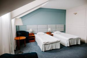 Łóżko lub łóżka w pokoju w obiekcie Hotel Senator