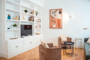 a living room with white shelves and a tv at My City Home - Amplio apartamento en Salamanca in Madrid