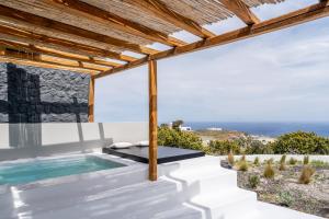 a pool with a view of the ocean from a house at Abrazo Villas in Imerovigli