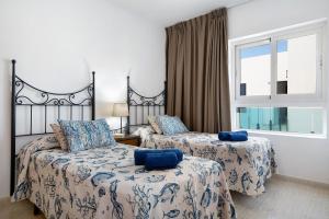 a bedroom with two beds and a window at Callao Beach 6 in Arrieta