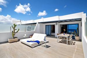 a bedroom with a bed and a table on a balcony at Callao Beach 6 in Arrieta