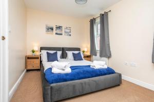 a bedroom with a large bed with two towels on it at Durham Heights in Leyland