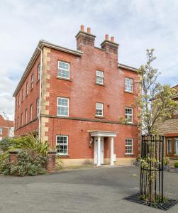 a red brick building with a gate in front of it at Durham Heights in Leyland