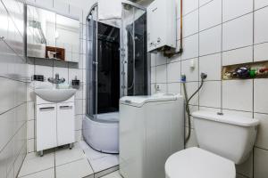 a bathroom with a toilet and a sink at HappyStay Grandma Apartment in Gdańsk