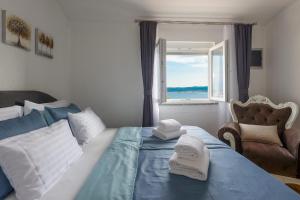 a bedroom with a bed with towels on it at Apartments Alen in Crikvenica