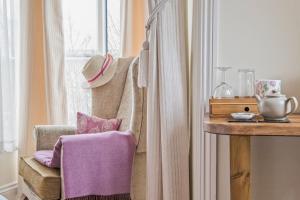 a room with a chair and a table and a window at Sheriff Lodge in Matlock