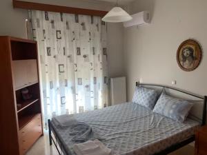 a bedroom with a bed with a curtain and a window at Savvinas House Faliraki-Traganou Beach in Faliraki