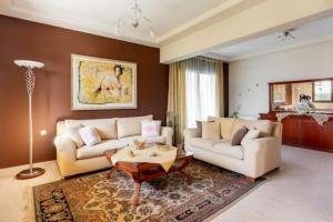 a living room with two couches and a coffee table at Savvinas House Faliraki-Traganou Beach in Faliraki