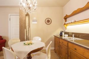 a dining room with a table and a sink at La Perla Apartment in Verona