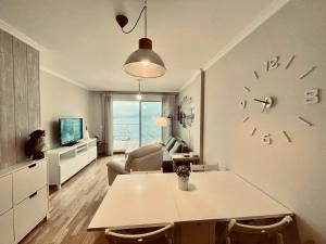 a living room with a large clock on the wall at Casa Da Moura in Combarro