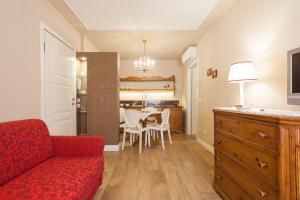 a living room with a red couch and a table at La Perla Apartment in Verona