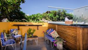 a patio with chairs and a bar on a balcony at Hotel Boutique Casa Mia in Santa Marta