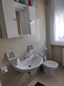 a bathroom with a sink and a toilet at Residenza al Lago in Germignaga +18 photos