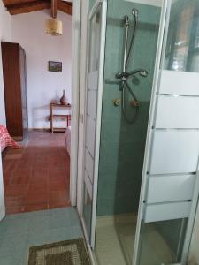 a shower in a bathroom with a glass door at Villette Monte Alto in Patti