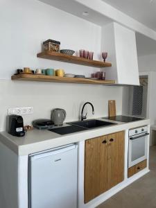 a kitchen with a sink and a stove top oven at Konstantza's Elegant Apartment in Naxos Chora
