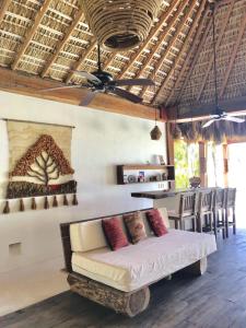 a living room with a couch and a table at Oceanfront Casa Rhino in Paso Hondo