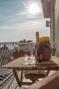 a table with a bottle of wine and a basket of fruit at Apartment Hedonist in Hvar