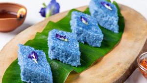 a bunch of blue food on a green leaf at Aloe Vera villa in Negombo