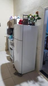 a white refrigerator with a plant on top of it at CASA DE TEMPORADA RECANTO FELIz 2 in Aracaju