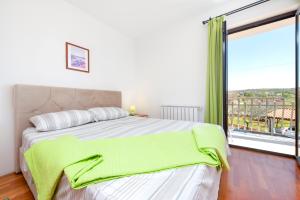 a bedroom with a large bed and a large window at Villa Mara in Rovinj