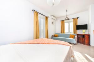 a bedroom with a bed and a blue couch at Villa Mara in Rovinj