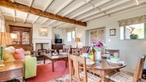 a living room with a table and chairs at Railway Cottage 