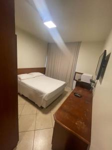 a bedroom with a bed and a dresser in it at MIX APART Hotel in Brasília