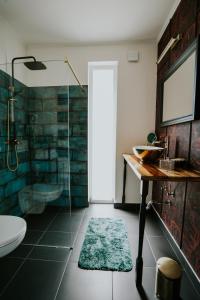 a bathroom with a shower and a sink and a toilet at Halacs Homes- Boutique cabins, Boutique Cabin in Balatonalmádi