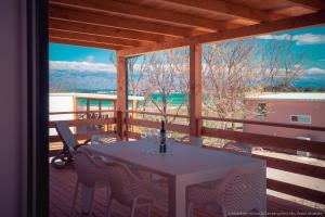 a table and chairs on a porch with a view at Mobilheim Maja in Nin