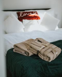 a towel sitting on top of a bed at Halacs Homes- Boutique cabins, Boutique Cabin in Balatonalmádi
